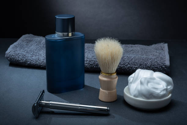 Closeup of men's toilet accessories: a razor, a shaving brush and some shaving foam. stock photo