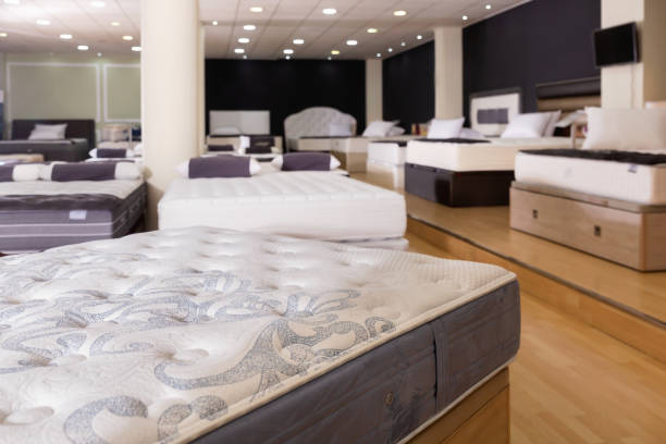 Closeup of new modern orthopaedic mattress on display for sale in large furniture store stock photo