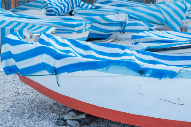 Closeup of old boats with blue and white sail stock photo