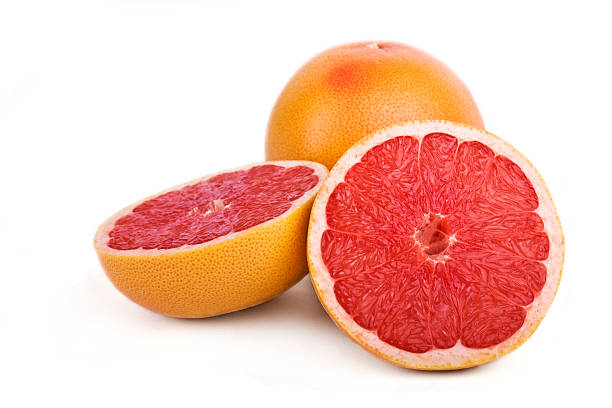 Close-up of one sliced and one full grapefruit stock photo