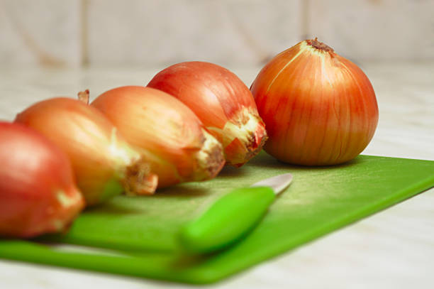 Close-up of onions on the kitchen table. stock photo