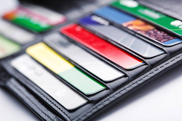 Close-up of open wallet with many credit cards in slots Black leather wallet with credit and discount cards pile of credit cards stock pictures, royalty-free photos & images