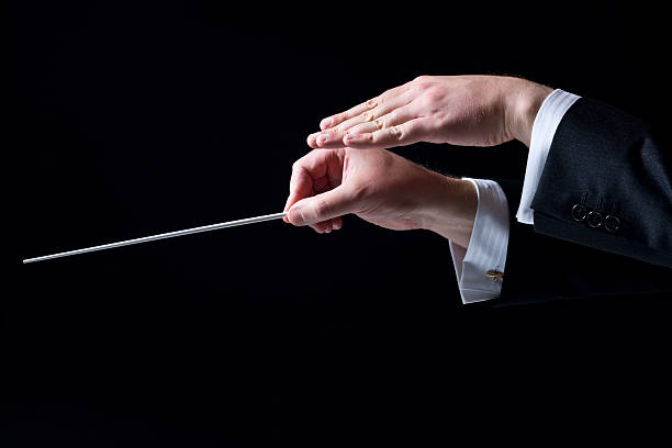 Close-up of Orchestra Conductor's Hands, Isolated on Black stock photo