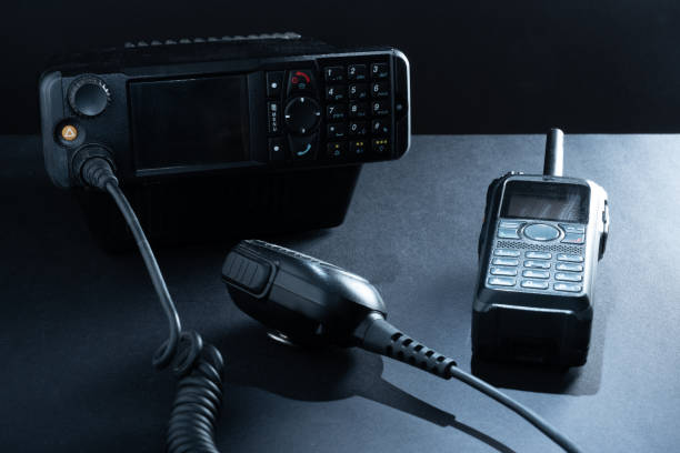 Closeup of pair of mobile two-way radios for Amateur radio operators against dark background. stock photo