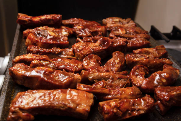 closeup of roasted pork ribs with barbecue sauce and caramelized with honey. Tasty homemade snack or small business ow stock photo