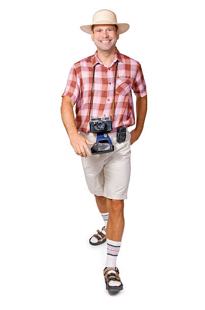 Close-up of smiling hiker in summer clothes holding a camera stock photo