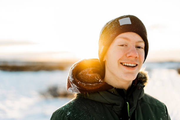 Close-up of smiling teenage boy during sunset stock photo