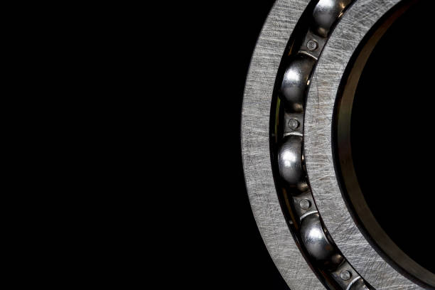 Closeup of Steel Roller bearings on black background. stock photo