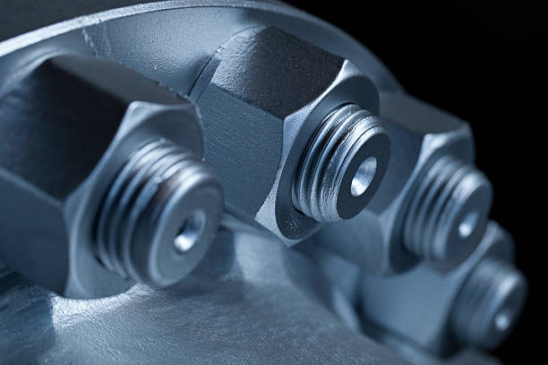 Close-up of the joint of two flanges by bolts and nuts  Joint of two flanges by bolts and nuts bolt fastener stock pictures, royalty-free photos & images
