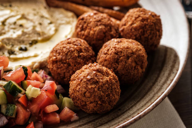 Close-up of Traditional falafel balls with salad and hummus on a plate stock photo