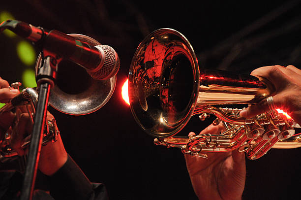 Close-up of trumpets being played into microphone stock photo