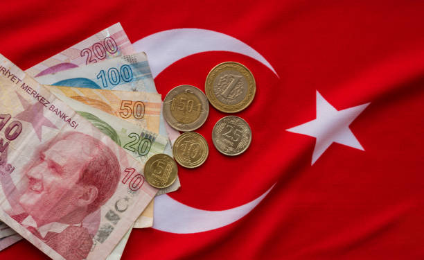 Close-up of Turkish Lira on Turkish Flag. stock photo