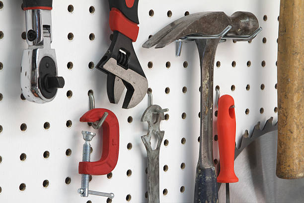 Close-up of various tools hanging Various tools organized on pegboard pegboard stock pictures, royalty-free photos & images