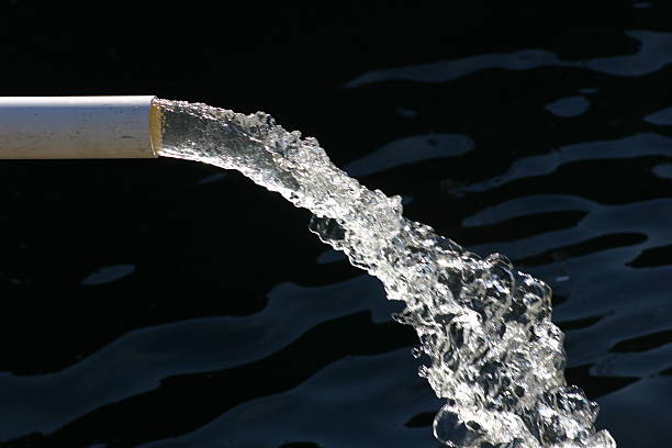 Close-up of water pipe with pouring water stock photo