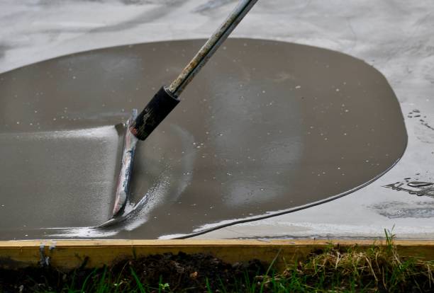 A Close-Up of Wet Concrete Being Spread For an Overlay stock photo