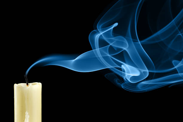 Close-up of white extinguished candle with curling up smoke stock photo