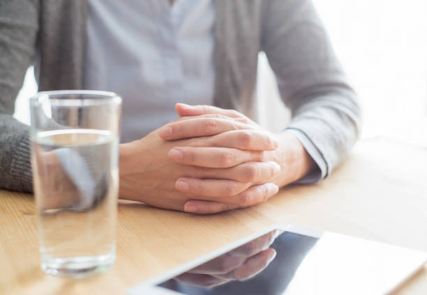 closeup-of-woman-at-table-with-tablet-and-water-picture