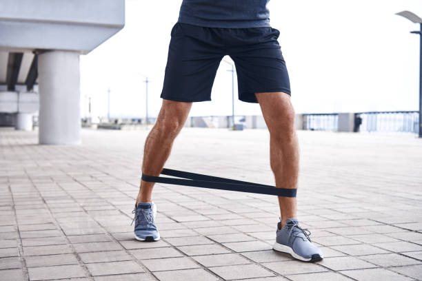 man uses resistance band for exercising