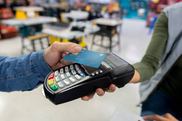 Close-up on a customer making a contactless payment at a hardware store