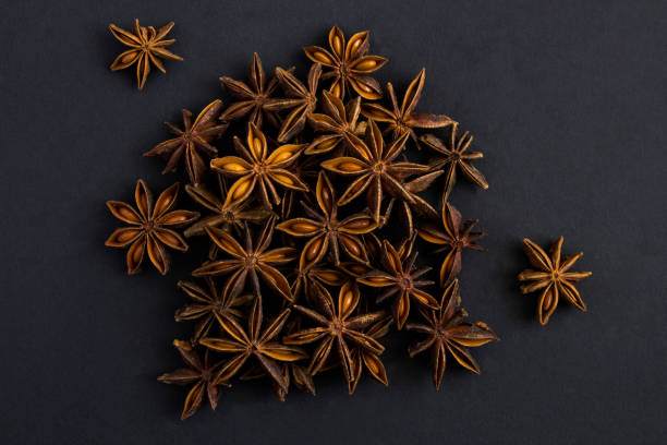 Close-up on dried anise star on the black background. Top view. stock photo