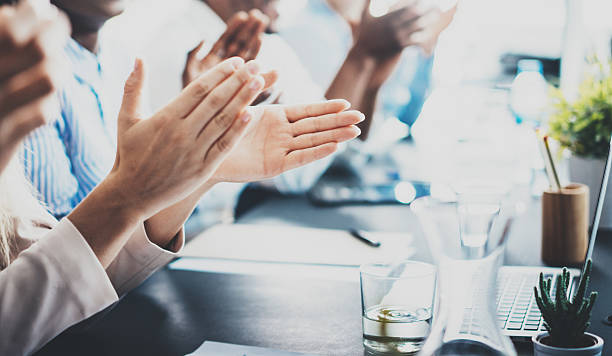 Closeup photo of partners clapping hands after business seminar. Professional stock photo
