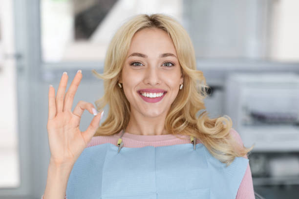 Closeup portrait of happy millennial woman visiting dental clinic stock photo