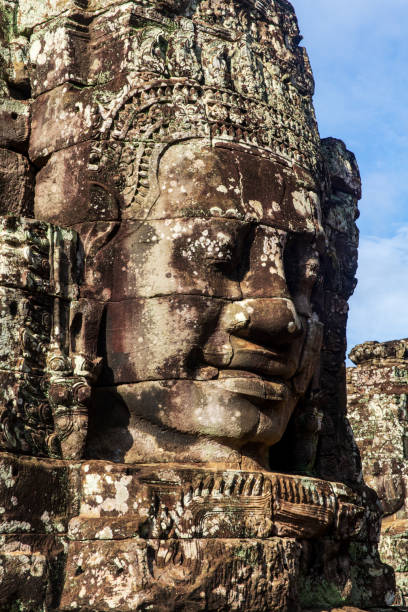 Close-up portrait of one of the Face tower in the Bayon temple in Angkor. Cambodia. Vertical view. stock photo