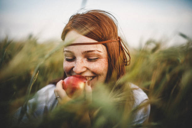 close-up portrait of young woman - woman happy eat stock-fotos und bilder