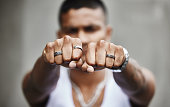 istock Closeup shot of a man's hands showing off his rings with clenched fists 1319805156