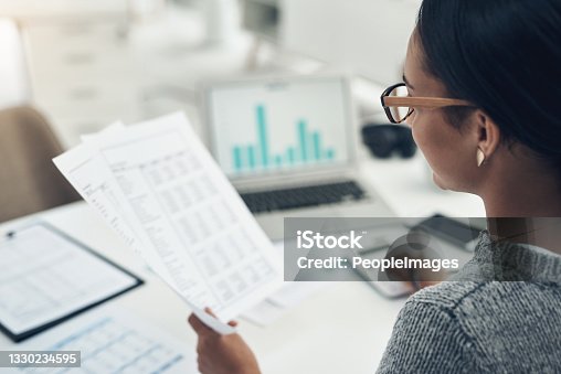 istock Closeup shot of an unrecognisable businesswoman calculating finances in an office 1330234595