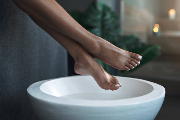 Closeup shot of an unrecognisable woman getting a foot treatment at a spa stock photo