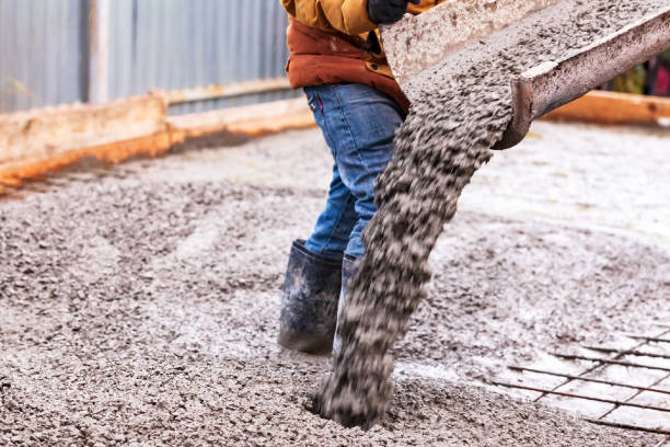 Closeup shot of concrete casting on reinforcing metal bars of floor in industrial construction site stock photo