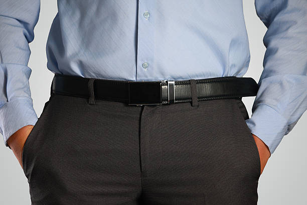 Closeup Shot of Male Waist with Hands in Pocket Photo image closeup shot of male waist with hands in pocket dressed in black pants, belt, blue shirt. Formal wear belt stock pictures, royalty-free photos & images