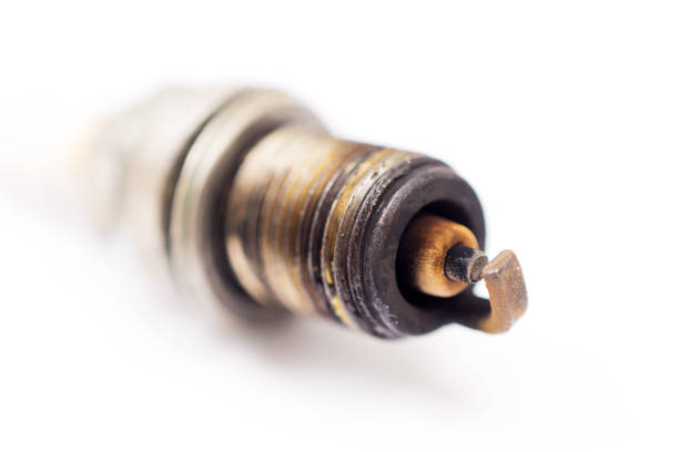 closeup shot of used spark plug on white background stock photo