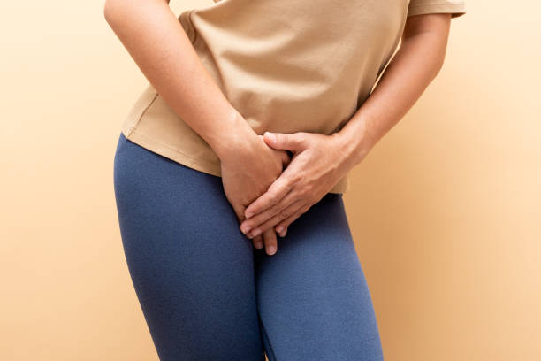 Closeup sick woman with hands holding pressing her crotch isolated on background stock photo