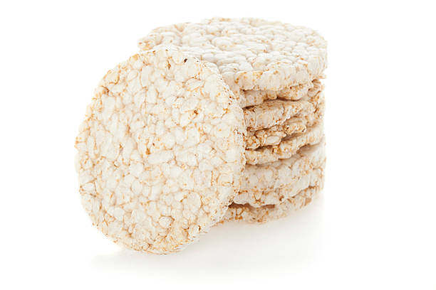 close-up stack of diet rice cakes on white background - rice puffs stock ph...