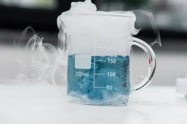 Close-up view of flask with blue reagent and steam in chemical lab Close-up view of flask with blue reagent and steam in chemical lab chemical reaction stock pictures, royalty-free photos & images