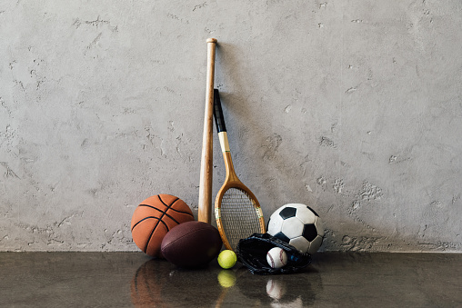 Closeup View Of Various Balls And Sports Equipment Near Grey Wall Stock Photo - Download Image ...