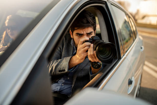 Close-up - Young Man Photorapher Sitting In The Car Close-up - Young Man Photorapher Sitting In The Car car photos stock pictures, royalty-free photos & images