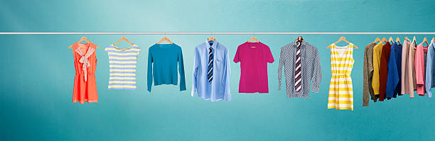 Clothes hanging on rail Clothes hanging on rail clothes rack stock pictures, royalty-free photos & images