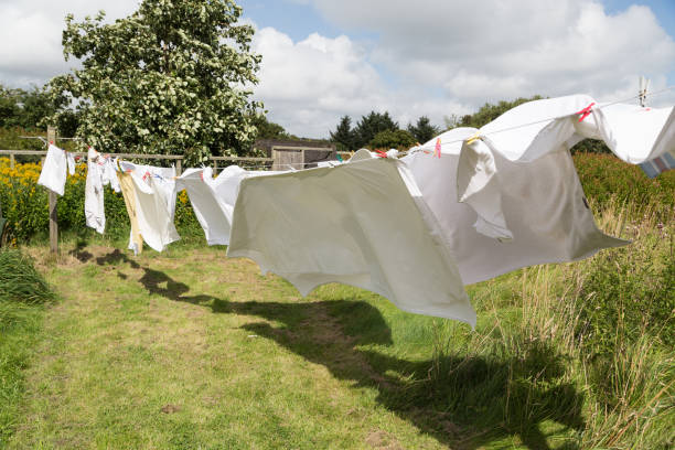 clothes line bed linen drying on a clothes line in the garden drying stock pictures, royalty-free photos & images