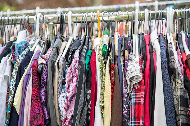 clothes on a rack in a flea market clothes on a rack in a flea market clothes rack stock pictures, royalty-free photos & images