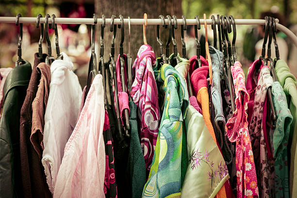 clothes on a rack on a flea market clothes on a rack on a flea market. thrift store stock pictures, royalty-free photos & images
