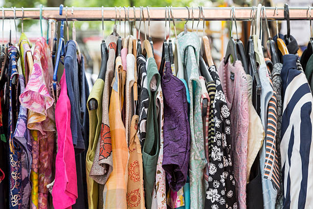 clothes on a rack on a flea market clothes on a rack on a flea market. clothes rack stock pictures, royalty-free photos & images