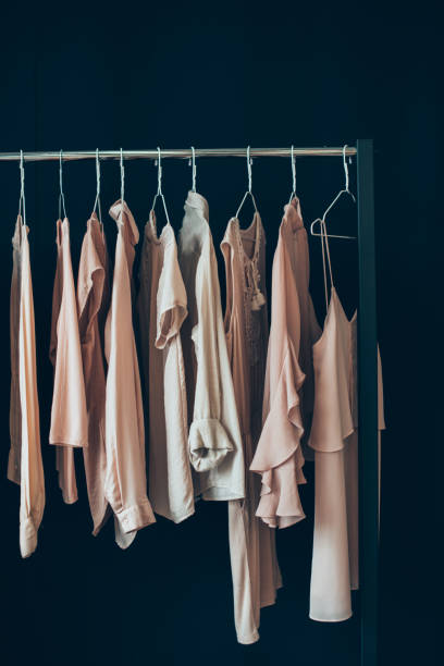clothing hanging on clothes rack close up view of arranged feminine clothing hanging on clothes rack clothes rack stock pictures, royalty-free photos & images