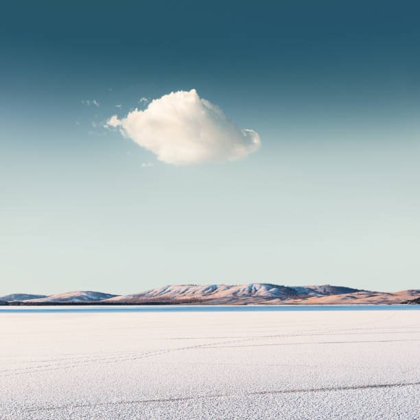Cloud over a frozen lake stock photo