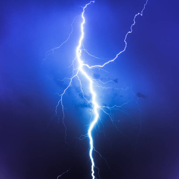 Cloud Typologies, lightning on blue sky big lightning strike in thunderstorm showing electricity and high voltage of extreme weather lightning photos stock pictures, royalty-free photos & images