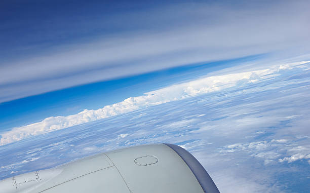 Clouds blue sky and reaction turbine - view from airliner stock photo