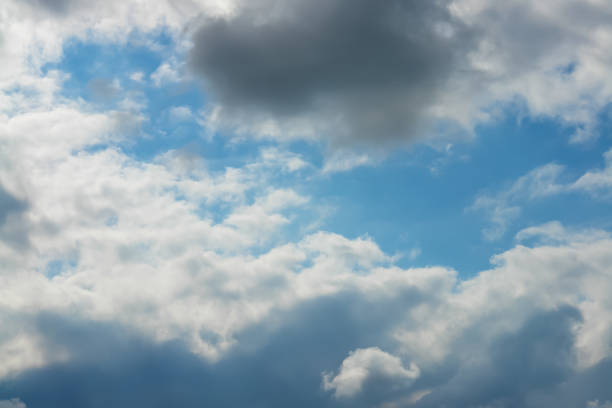 Clouds on the blue shiny sky stock photo