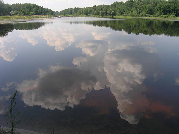 clouds reflected in the lake stock photo